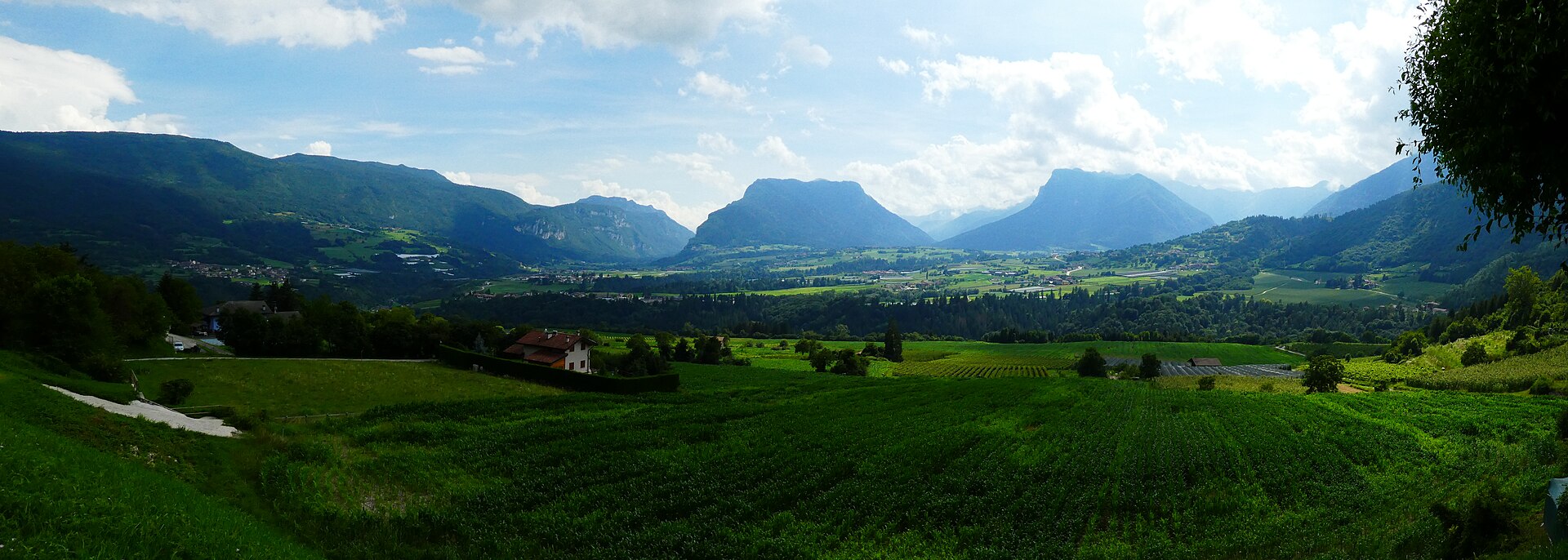 Green fields and mountain scenery across the Bleggio and Lomaso plateaus