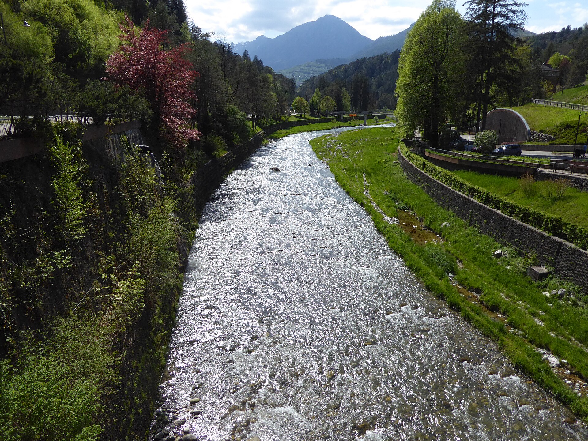 River Sarca flowing through the green landscape beside Terme di Comano