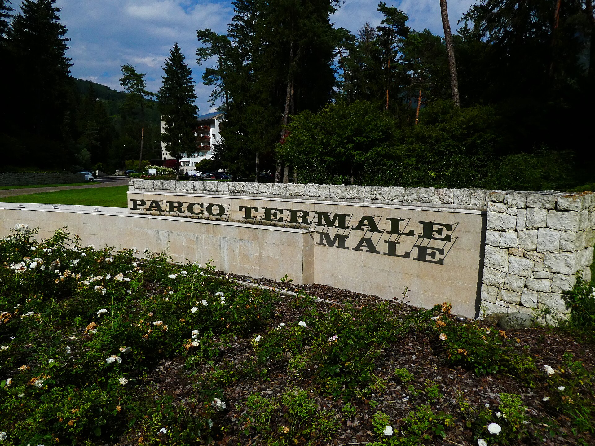 Entrance sign and wooded grounds of the Terme di Comano thermal park